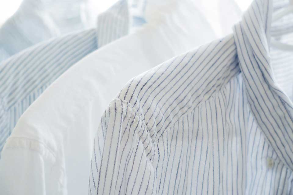Linen shirts hanging on a hanger.